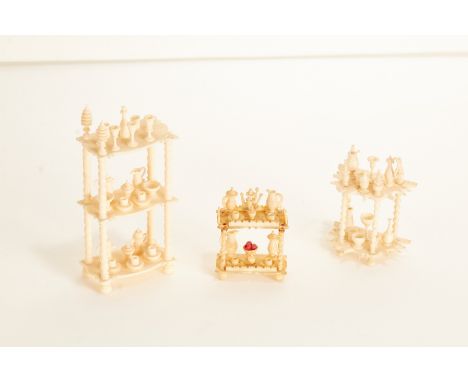 A mixed group of 19th century carved ivory prisoner of war work miniature whatnotsOne of three tiers with turned supports, ea