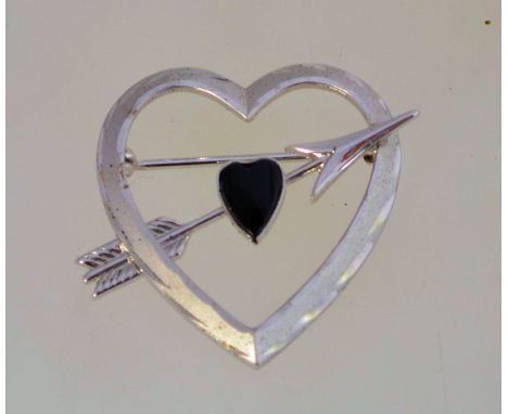 A vintage 1980 silver heart and arrow brooch set with black onyx, marked "STERLING" and measuring 3.2cms long.