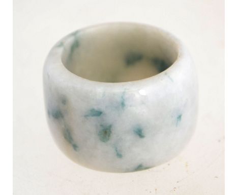 A wide jade ring.