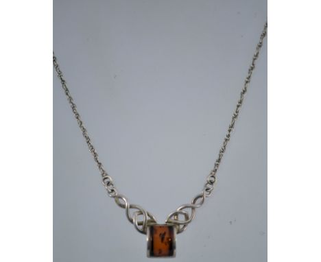 A silver and amber celtic style necklace with a lobster claw clasp. It is marked "925" and measures 41cms long.