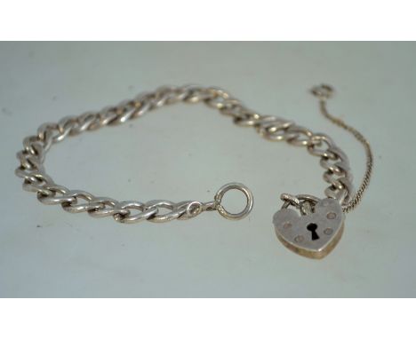 A vintage silver belcher chain bracelet with a heart padlock clasp and safety chain. It is marked "London 1977" and measures 