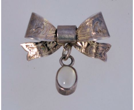 A vintage bow shaped fob brooch with an associated moonstone drop and roll over clasp. It is marked "Birmingham 1973" and mea