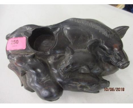 A rosewood inkwell in the form of a sow and her three piglets 
