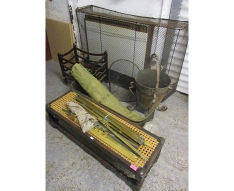 A mixed lot to include a cane foot stool, carpet rods, a fire guard and other items 