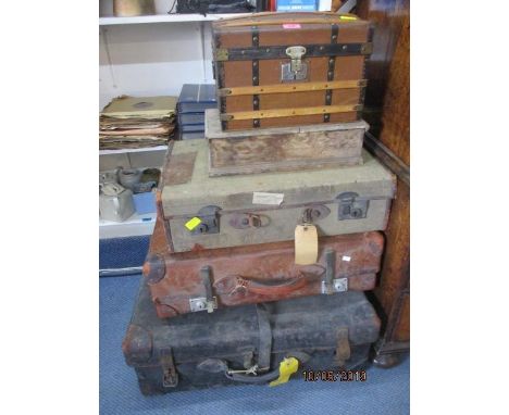 A quantity of vintage suitcases, a treen box and a mid 20th century treen casket 