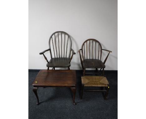 An Ercol armchair, armchair, coffee table and a rush seated stool 