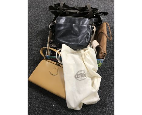 A box of tan leather hand bag, fossil hand bag with dust cover together with six other hand bags 