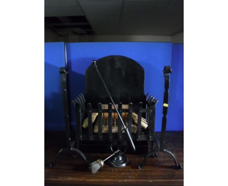 A cast iron fire grate, a pair of fire dogs, poker on stand and a cobbler's last 