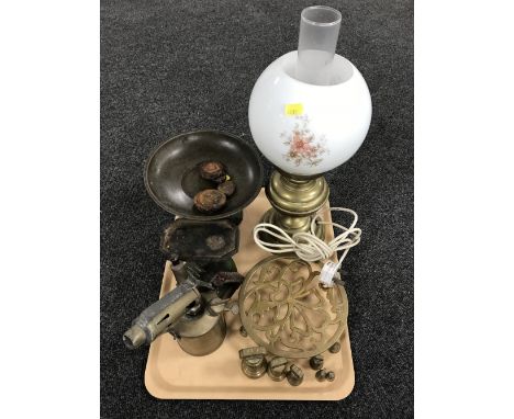 A tray of vintage brass blow torch, kitchen scales and weights, trivet, converted brass lamp