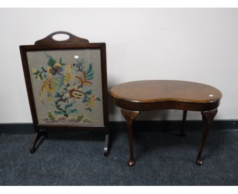 A walnut kidney shaped coffee table and an oak fire screen 