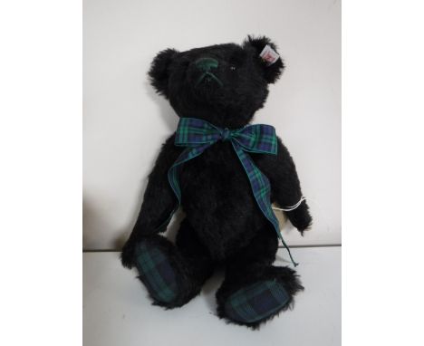 A Steiff black mohair bear - Black Watch musical bear, length 30 cm.