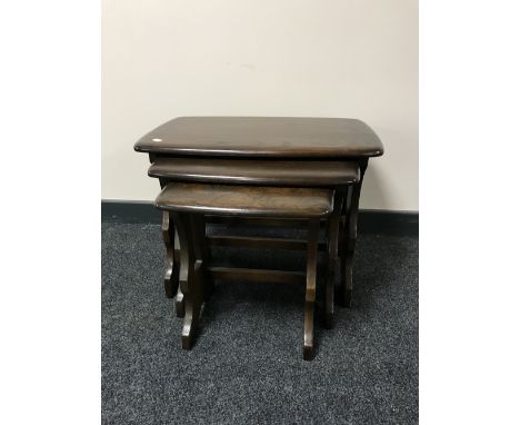 A nest of three Ercol elm tables 