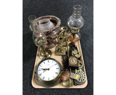 A tray of brass ware, oil lamps, miniature mantle clock, copper twin handled pot, candlesticks etc 
