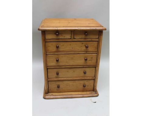 A LATE 19TH / EARLY 20TH CENTURY PINE FINISHED TABLE TOP MULTI-DRAWER CABINET, having plain carcase with two shallow inline d