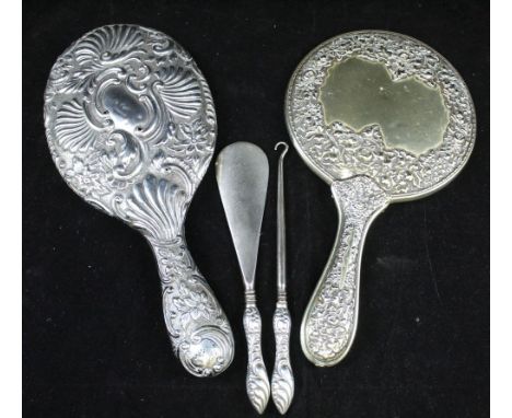 AN EDWARDIAN SILVER HAND HELD VANITY MIRROR, embossed decoration, London 1902, together with; one other hand held mirror, a b