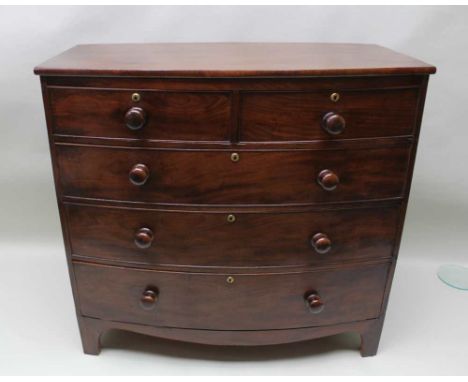 A 19TH CENTURY MAHOGANY BOWFRONT CHEST OF DRAWERS, having two inline, over three full width drawers, each with turned wooden 