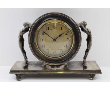 AN ART DECO MANTEL TIMEPIECE, silver plated case, with cast metal, mermaid figures flanking the centre section, the dial with