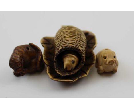 THREE LATE 20TH CENTURY JAPANESE CARVED WOOD NETSUKE, to include a Pupa emerging from a cocoon on a leaf, a piglet and one ot