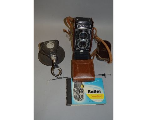 A ROLLEIFLEX 3.5 TLR CAMERA, with a Rollieflash, handbook, leather case distressed and a Weston Light Meter
