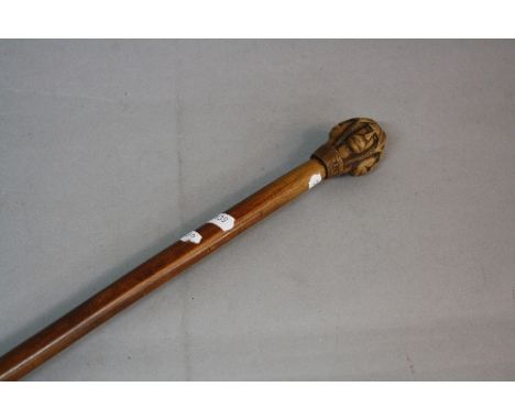 A LATE 19TH CENTURY KEPKYPA (CORFU) WALKING STICK, the wooden pommel carved as four male moustached faces, each intersperced 