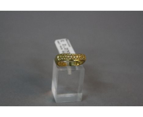 A MODERN 18CT GOLD PICCHIOTTI PAVE SET YELLOW DIAMOND HALF ETERNITY RING, smile design, yellow diamonds assessed as treated c