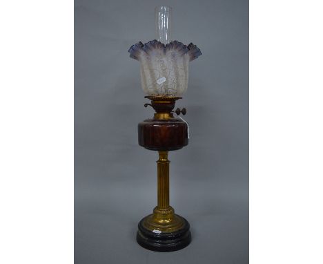 A LATE VICTORIAN OIL LAMP, the opaque glass shade with crackle moulding and wavy amethyst rim, amethyst glass reservoir, bras