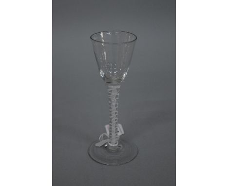 AN 18TH CENTURY CORDIAL GLASS, with rounded funnel shaped bowl and enamel double air twist stem, height approximately 15cm