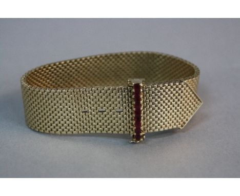 A MID-LATE 20TH CENTURY 9CT GOLD RUBY BRACELET, wide mesh link designed as a belt, feature ruby set fold over buckle, measuri