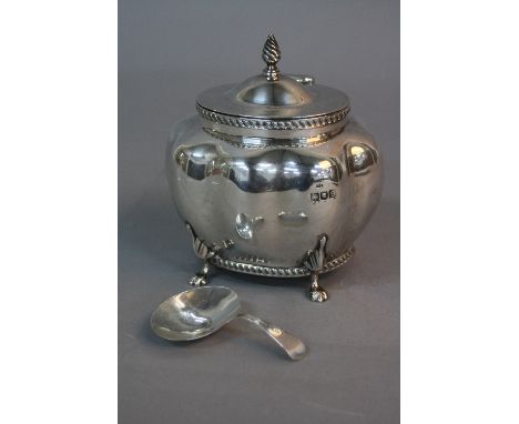 AN EDWARDIAN SILVER TEA CADDY, of lobed oval form, hinged cover, gadrooned rims, on four cabriole legs with paw feet, makers 