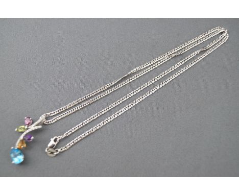 A white metal pendant set topaz, quartz and tourmaline and finished with diamonds. Suspended from a curb link chain. Stamped 