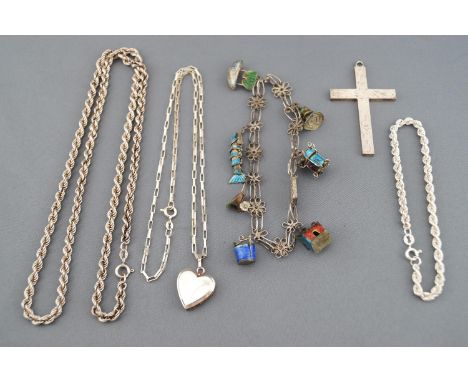 A collection of silver jewellery to include a large engraved cross pendant, a rope bracelet, a rope chain, a heart locket wit