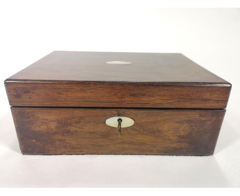 A 19th century rosewood writing slope of small form, the top and lock set with oval mother of pearl escutcheons, opening to r