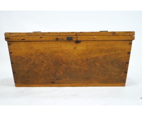 A pine trunk of tapered rectangular form, the top plank made over a dovetail joined panel base, 42cm high x 95cm wide x 51cm 