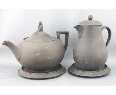A Wedgwood black basalt plain teapot of rounded form, the lid set with a finial in the form of a female figure draped in a cl