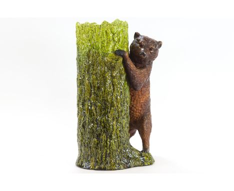 A Bretby pottery stick/umbrella stand, decorated with a figure of a bear, 66cm high