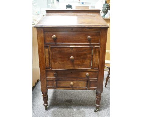 A Victorian and later mahogany clerk's desk on turned legs with brass and ceramic casters, 101cm high x 61cm wide x 58cm deep