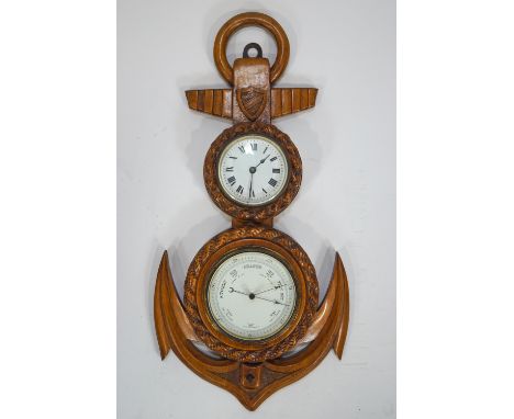 An oak cased  barometer with timepiece above, the oak case curved in the form of an anchor, 51cm high
