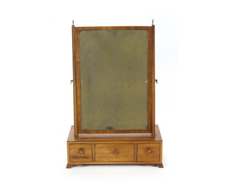 A 19th century mahogany swing frame mirror on rectangular base with three drawers on ogee bracket feet, 77cm high x 49cm wide