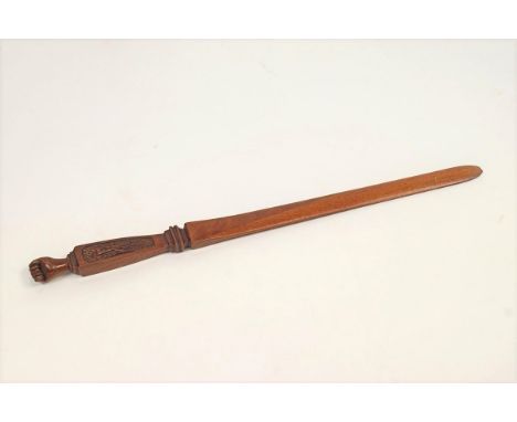 A Royal flying Corps carved mahogany letter opener, with a clenched hand finial, 31cm long