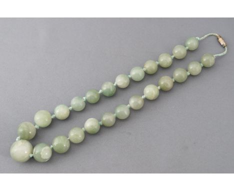 A single strand of graduated polished green beads, strung knotted with a gold plated screw clasp.  tests indicated Jadeite Ja