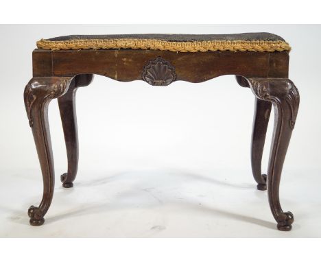 A 18th century style mahogany stool with inset tapestry seat, the frieze carved with shells on cabriole legs, 47cm high x 61c