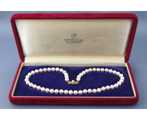 A single strand of cultured akoya pearls by Mikimoto. Measuring 6.5mm to 7mm. Strand length: 15 inches. Strung knotted with a
