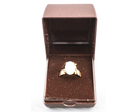 A yellow metal single stone ring set with an oval cabochon cut opal. Stamped 9ct. Size: P 3.2 grams