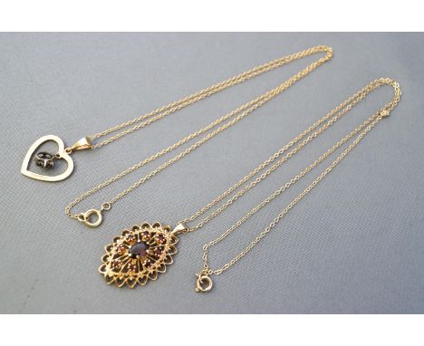 A hallmarked 9ct gold garnet cluster pendant with chain together with a hallmarked 9ct gold heart pendant with suspended sapp
