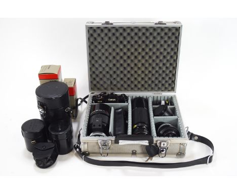 A Canon ES camera with 500mm reflex lens, 100-300mm zoom lens, 50mm lens, 24mm lens and accessories together with aluminium c