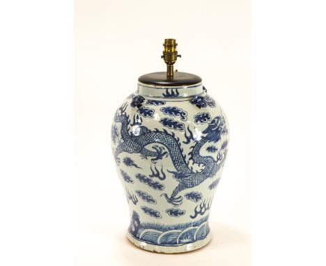 A Chinese porcelain vase, painted in underglaze blue with dragons chasing the flaming pearl, converted to a table lamp, 37cm 