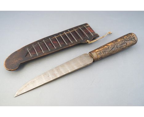 A North African dagger and another from Java, the former with a steel blade set in a horn handle, set in a similar metal scab