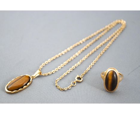 A hallmarked 9ct yellow gold single stone tigers eye ring together with a matching tigers eye pendant set in gold plated moun