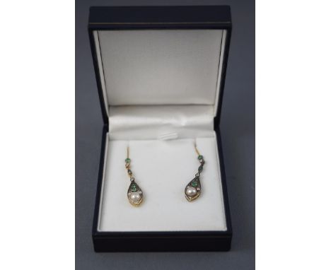 A yellow and white metal pair of drop earrings, set with emeralds, diamonds and a freshwater pearl. Hook fitting. No hallmark