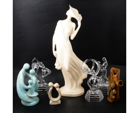 An Art Deco ceramic figure, 59.5cm; an RCR glass model of a mother and child, 25.5cm; another of a dancing nude, 27.5cm; anot